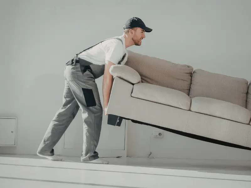 man moving sofa - furniture placement tips